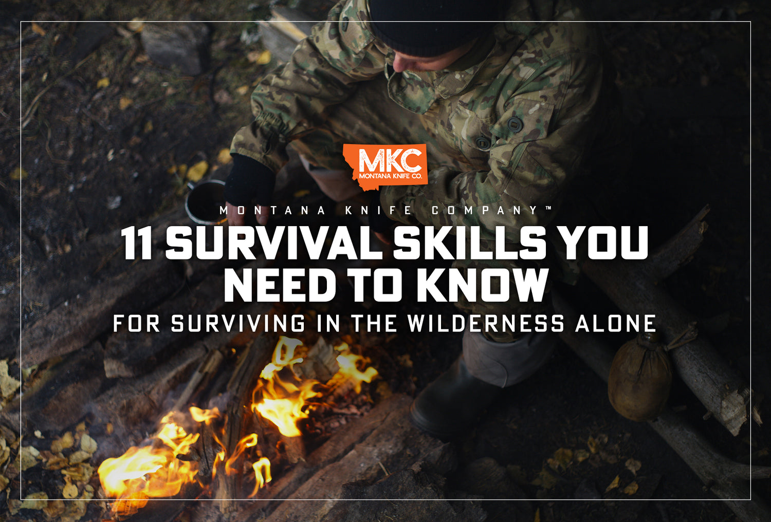 A man wearing camo sits by a fire he started by using one of his skills for surviving in the wilderness.