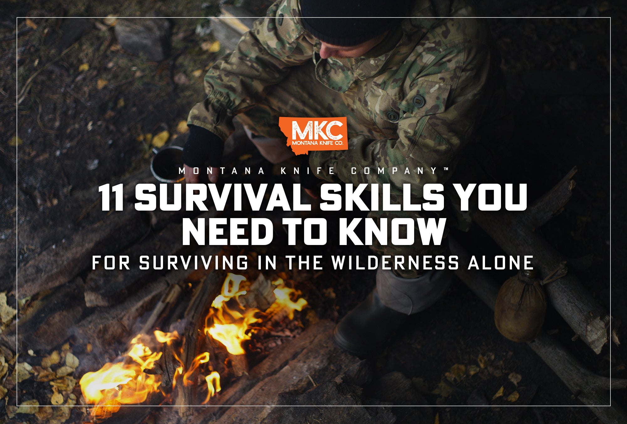 A man wearing camo sits by a fire he started by using one of his skills for surviving in the wilderness.
