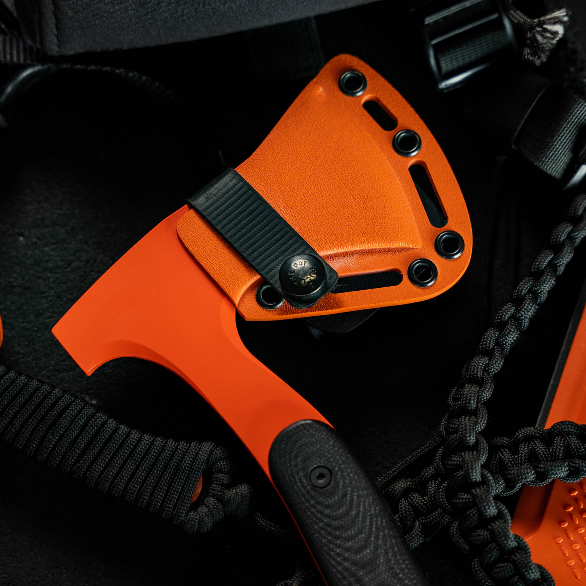HELLGATE HATCHET with an orange Kydex sheath, showcasing its durable design for outdoor and tactical use.