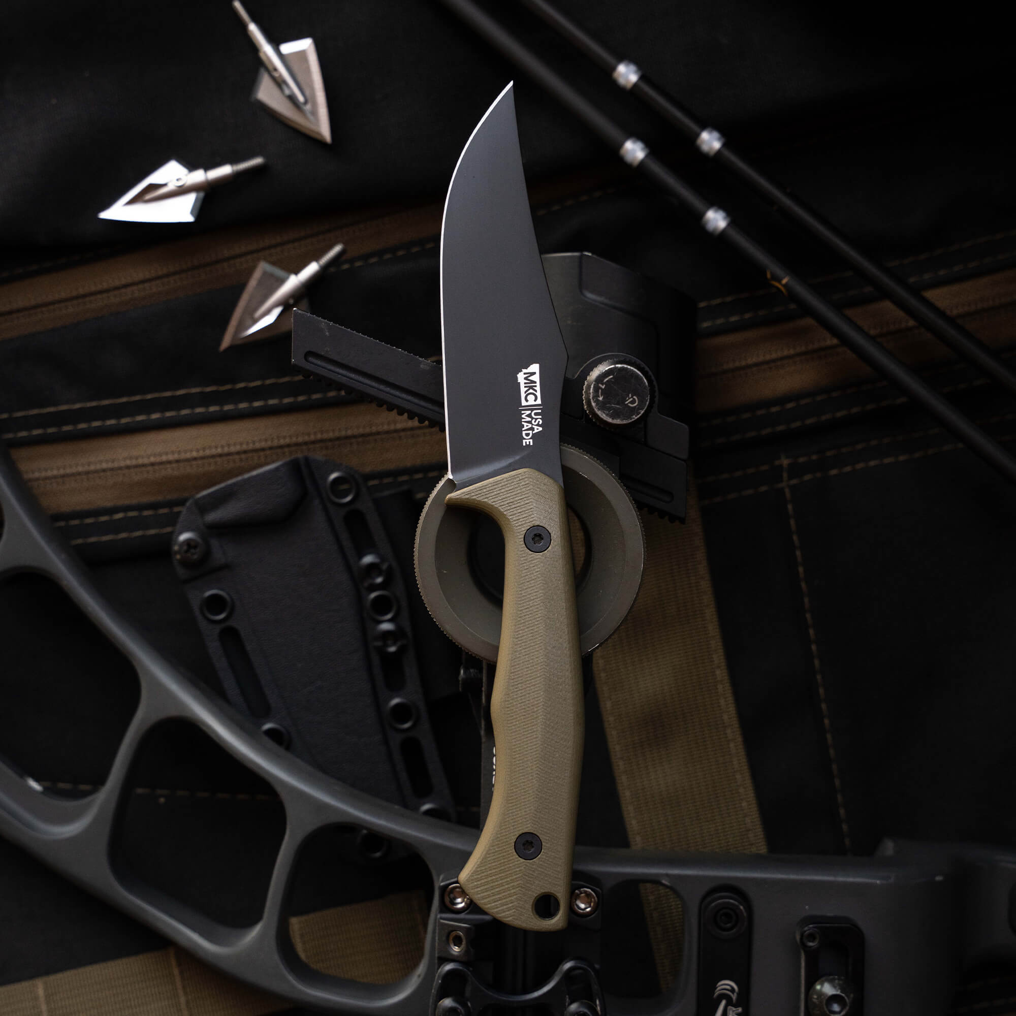 Montana Knife Company's Nock On Triumph Pro knife displayed on a tactical background with archery equipment.