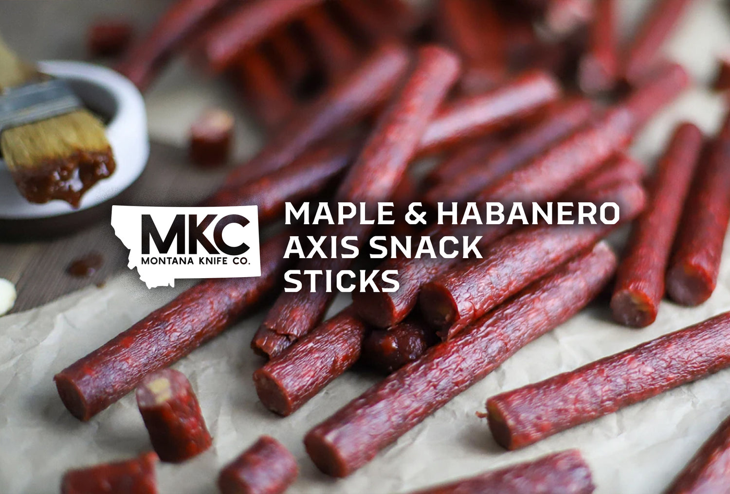 Venison meat sticks are sitting on a table with the overlay “Maple & Habanero Axis Snack Sticks.”