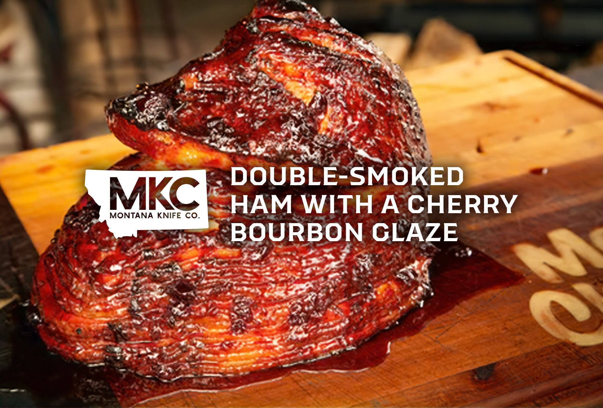 Double-smoked ham with a rich cherry bourbon glaze, glistening and caramelized, displayed on a wooden cutting board.