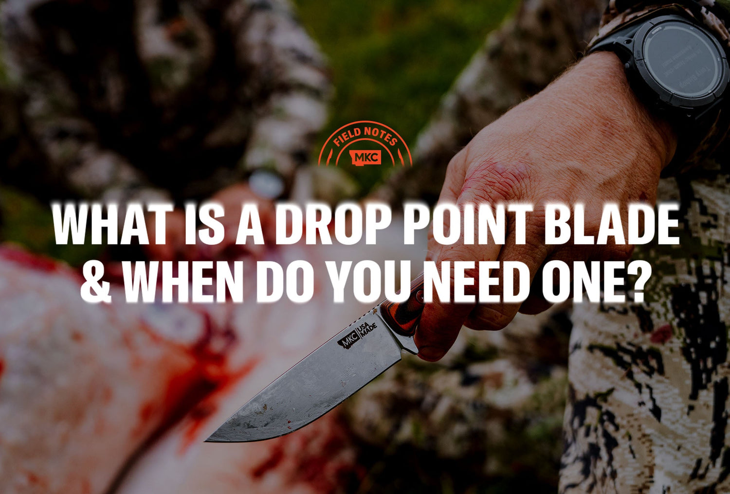 Close‑up of a hand gripping an MKC drop point knife outdoors.