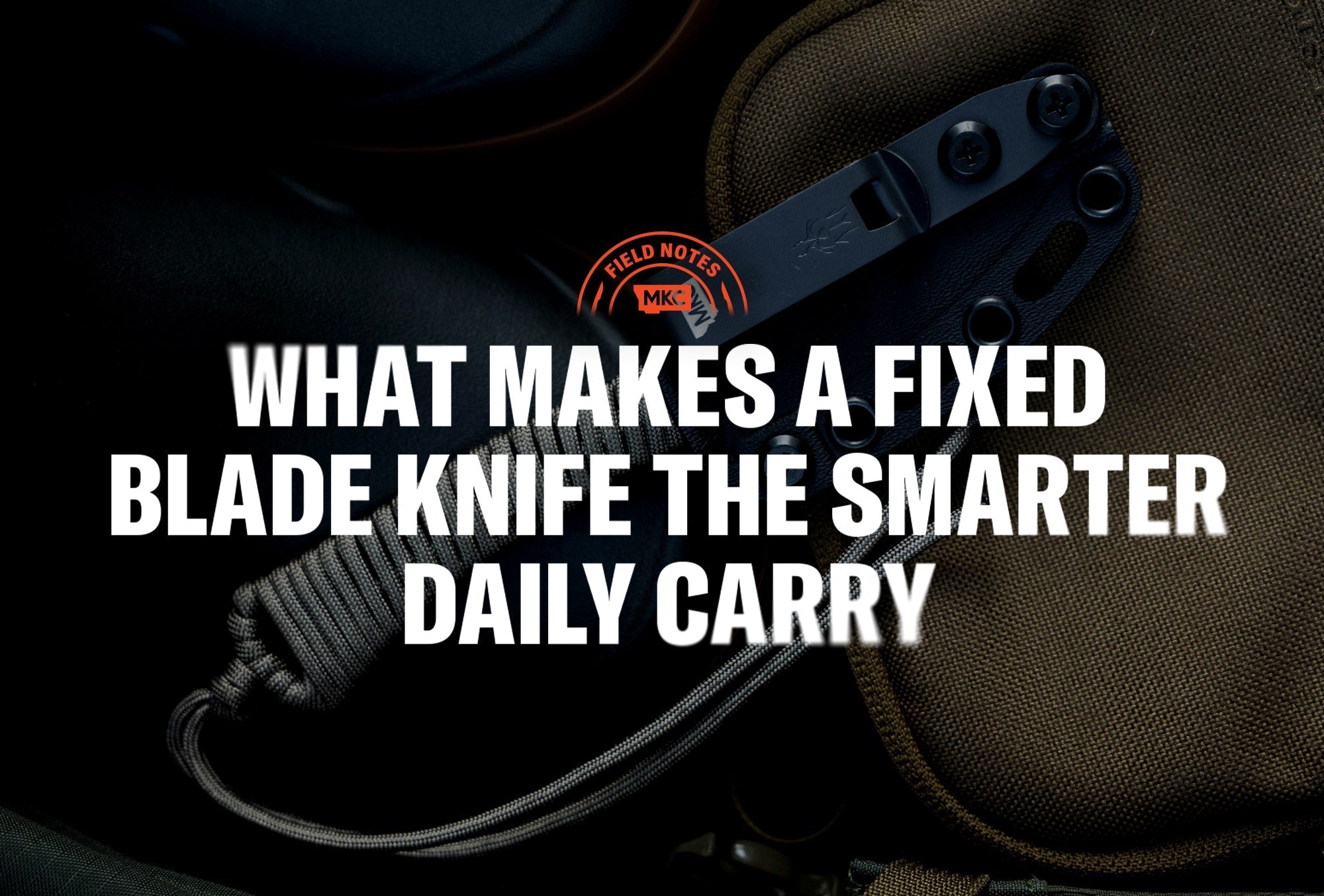 Fixed blade knife with paracord handle resting on dark fabric, shown for a fixed blade knife guide.