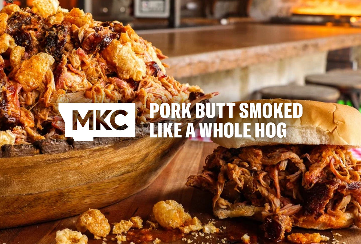 Wooden bowl of smoked pulled pork with pork rinds and a pulled pork sandwich.