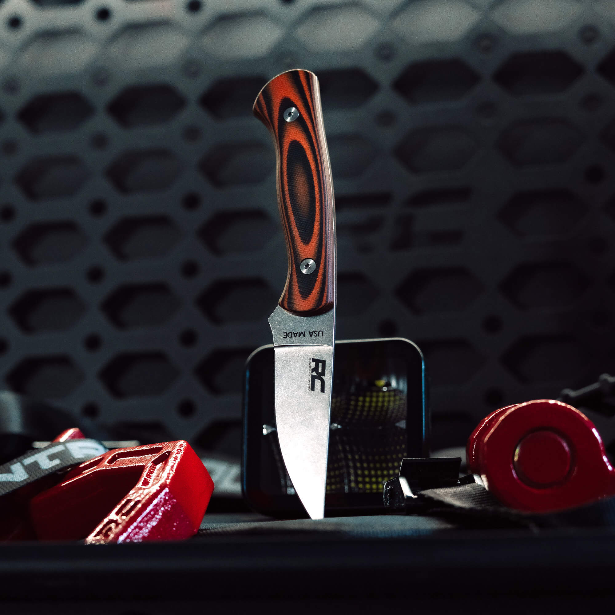 Rough Country Magnacut Blackfoot 2.0 knife with a sleek blade and striking handle, set against a rugged background.