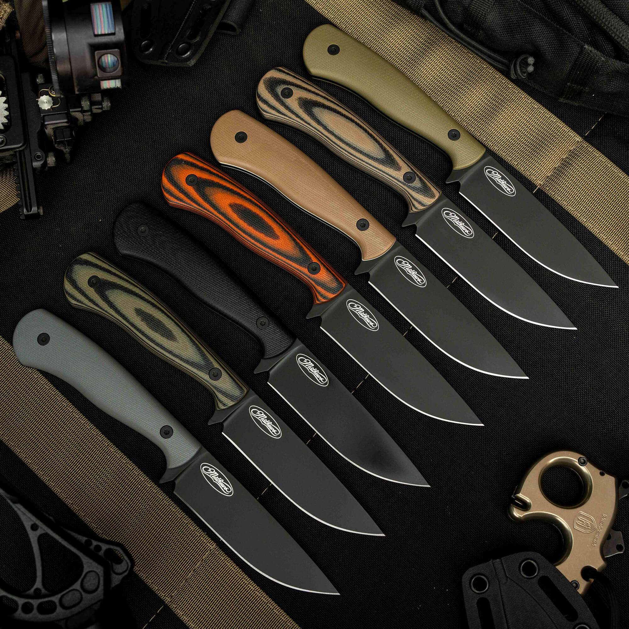 A lineup of MKC Whitetail knives featuring various handle colors and finishes, showcasing their sleek blades and ergonomic designs.