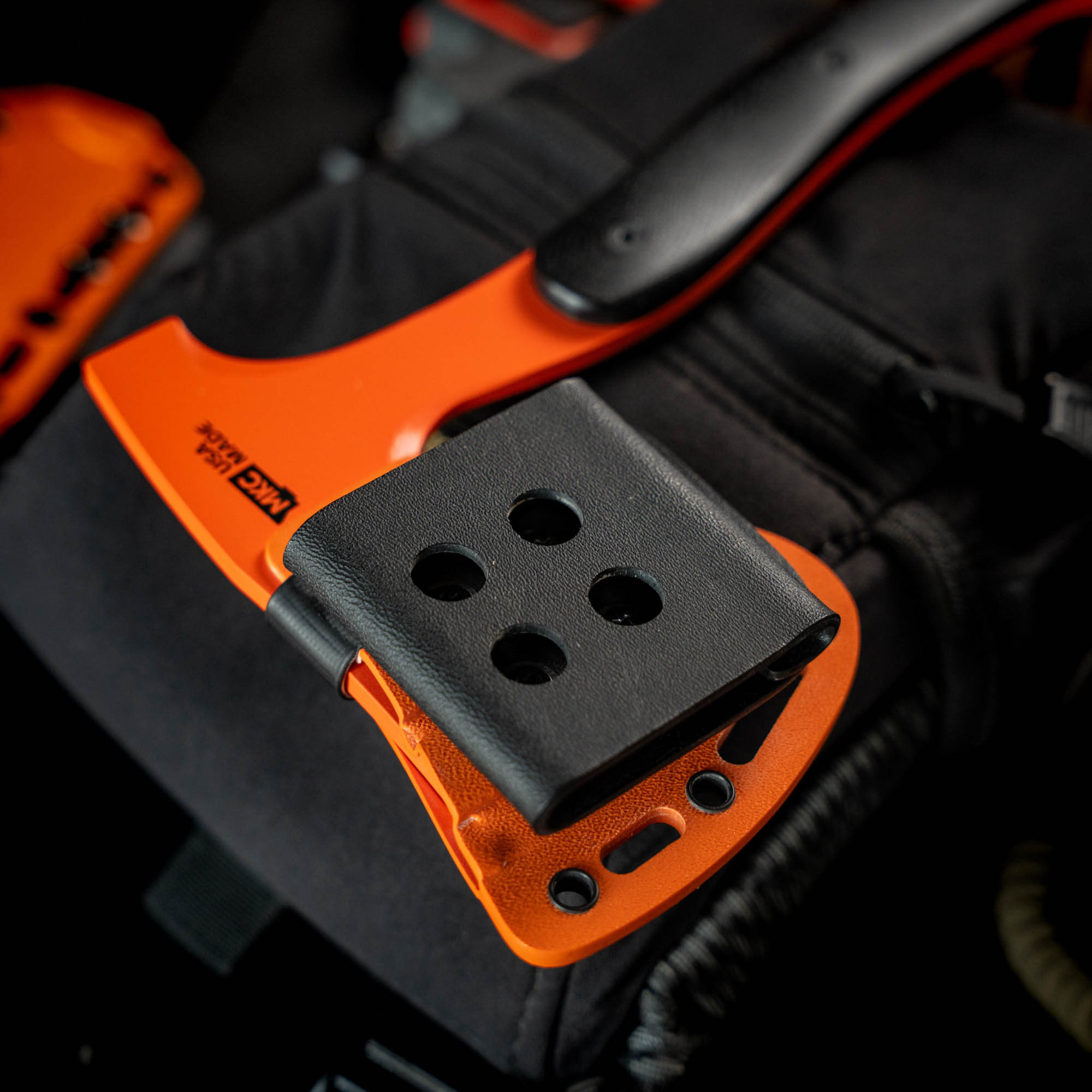 HELLGATE HATCHET with an additional Kydex sheath, showcasing the vibrant orange handle and secure attachment.