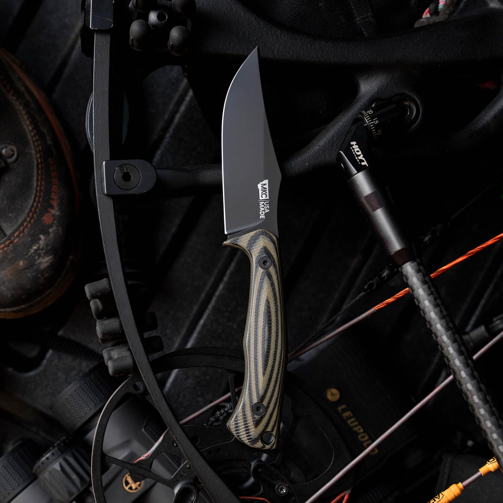 Montana Knife Company's Nock On Triumph Pro knife displayed on a bow, showcasing its sleek design and durable materials.