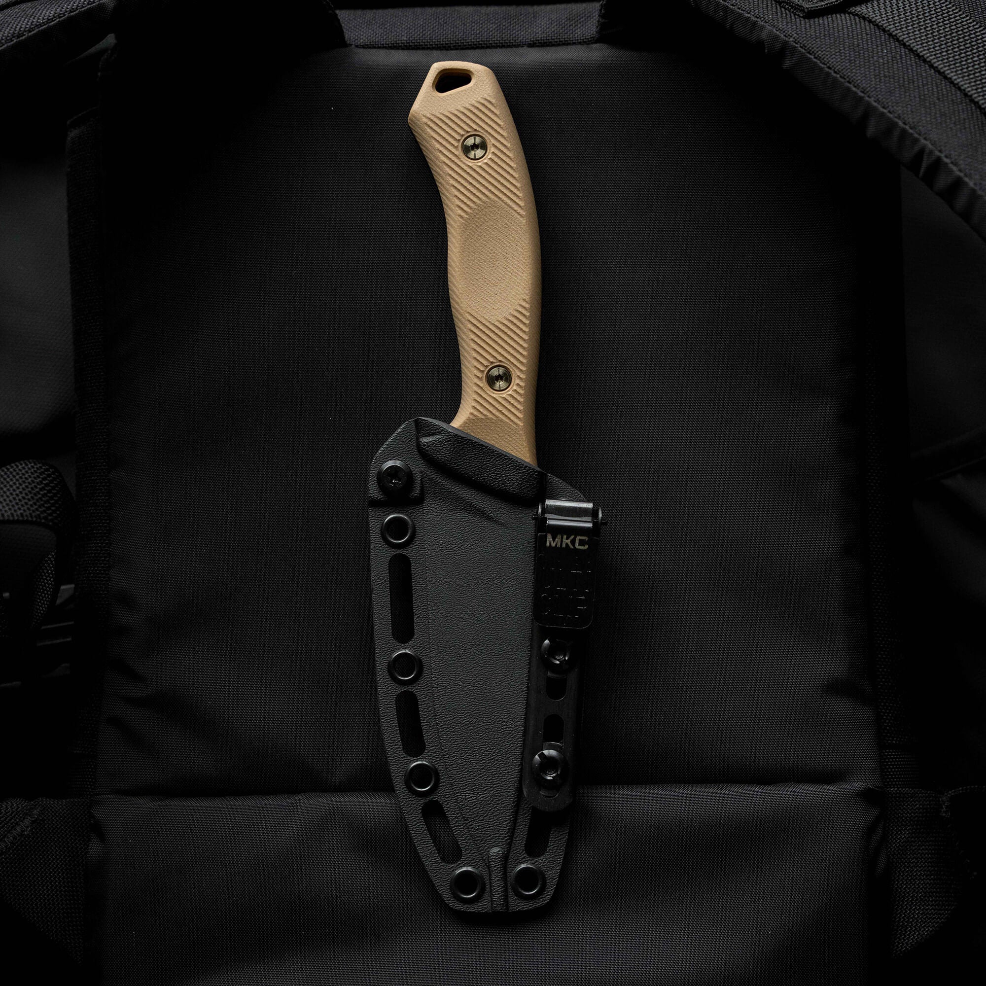 MTNTOUGH TF24 knife with a tan handle and black sheath, designed for durability and outdoor use.